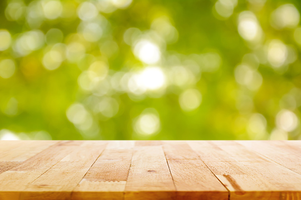 Wood table top on natural green bokeh abstract background - Foto, imagen