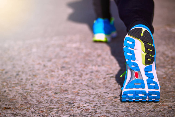 Foot closeup athlete running in sneakers outdoors. - Foto, imagen