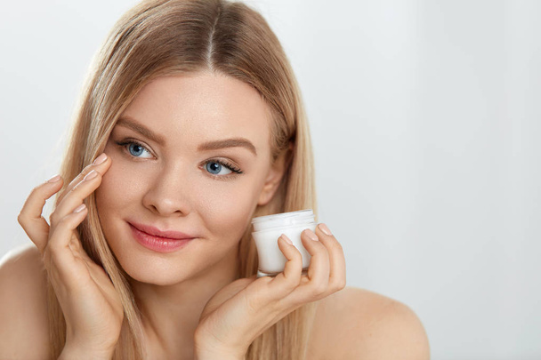 Woman Face Skin Cosmetics. Girl Applying Cream Under Eyes - Фото, зображення