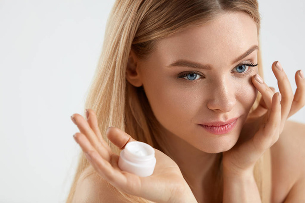 Beautiful Woman Applying Cream On Skin Under Eyes - Fotó, kép