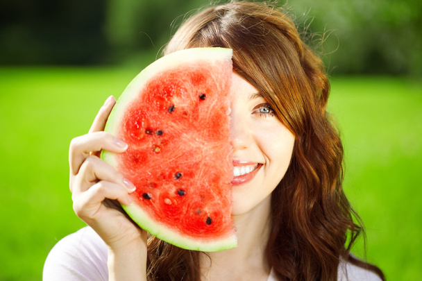 Woman with juicy watermelon in hands - 写真・画像