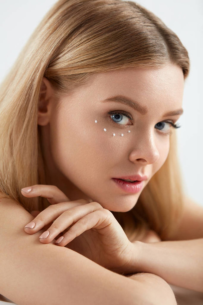 Beauty Cosmetics. Woman With Drops Of Eye Skin Cream On Skin - Zdjęcie, obraz