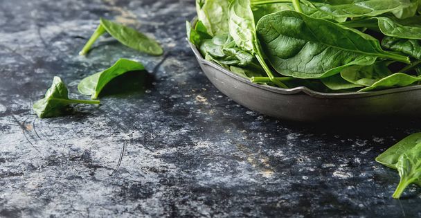 Washed fresh mini spinach on the old concrete table - Фото, зображення