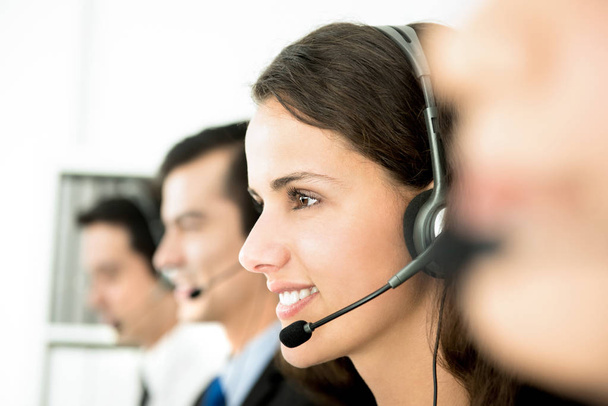 Smiling customer service team in call center - Photo, Image