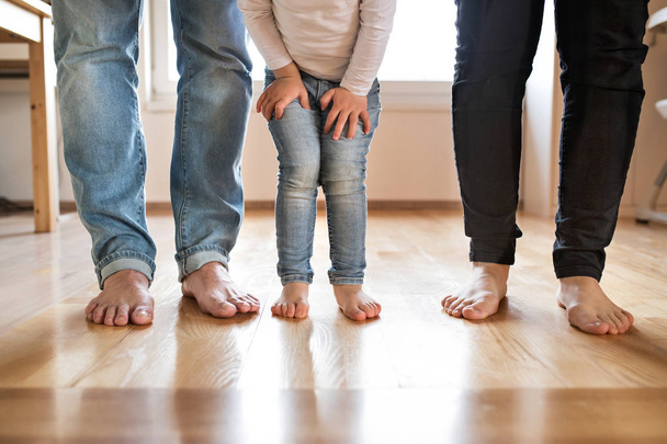 Beautiful young family. Bare feet of mother, father and daughter - 写真・画像
