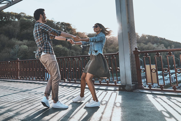 stylish young couple dancing on the bridge - Fotoğraf, Görsel