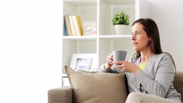 happy woman drinking tea or coffee at home - Video, Çekim