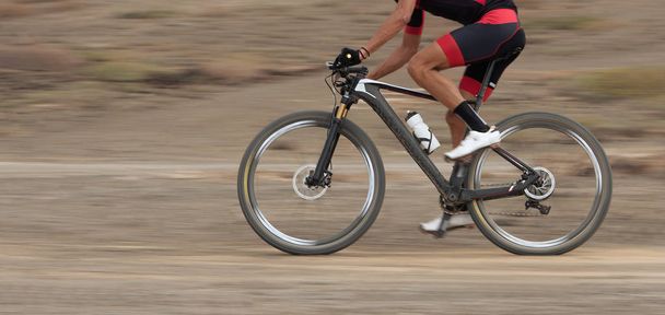 Motion blur of a mountain bike race with the bicycle and rider - Photo, Image