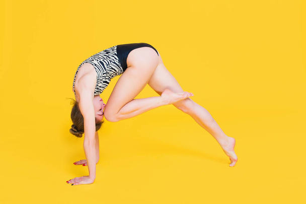 Young fit woman gymnast stretching - 写真・画像