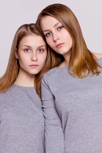 Two twin sisters snuggled, portrait - Zdjęcie, obraz