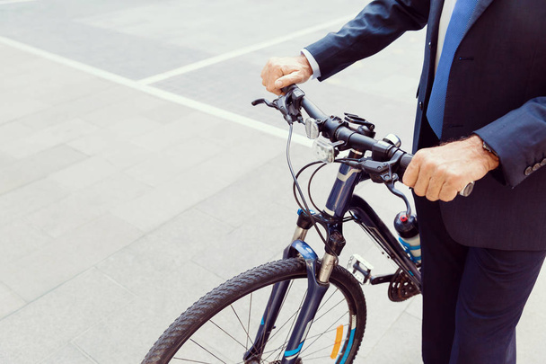 Successful businessman riding bicycle - Fotoğraf, Görsel