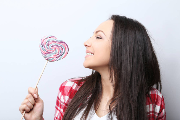 Young woman with lollipop - Zdjęcie, obraz