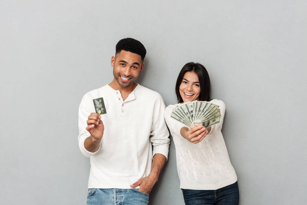 Woman and man showing credit card and cash - Photo, image