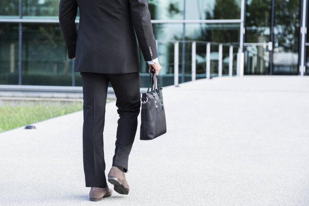 Businessman or worker standing in suit near office building - Photo, Image