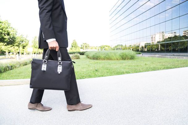 Businessman or worker standing in suit near office building - Φωτογραφία, εικόνα