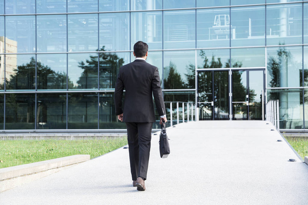 Businessman or worker standing in suit near office building - Foto, Imagen