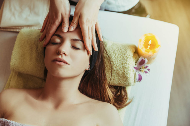 Young, beautiful and healthy woman in spa salon. Traditional oriental massage therapy and beauty treatments. - Φωτογραφία, εικόνα
