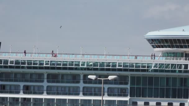Long shot of top of ocean liner with tourists walking - Footage, Video
