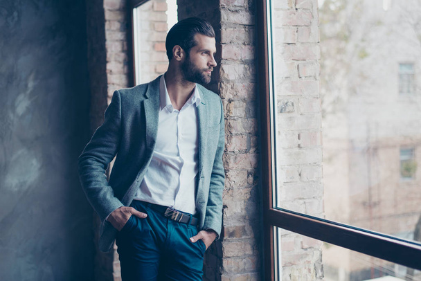 Success concept. Stylish young bearded man is standing near the  - Foto, immagini
