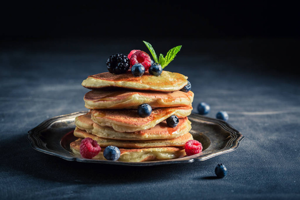 Tasty american pancakes with maple syrup and berries - Фото, зображення