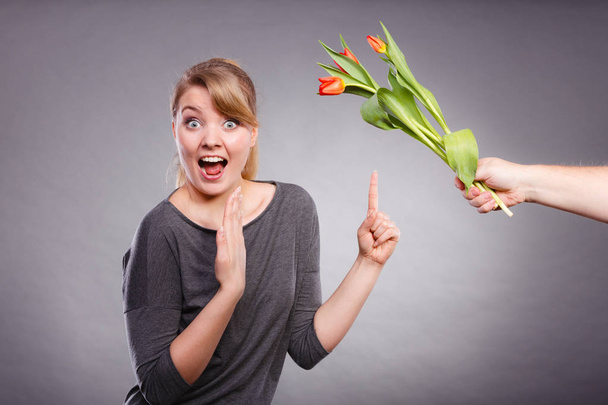 Woman gets bouquet of tulips from man. - Zdjęcie, obraz
