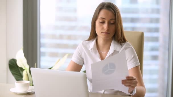 Attractive businesswoman using laptop, studying charts, making presentation, financial report - Video