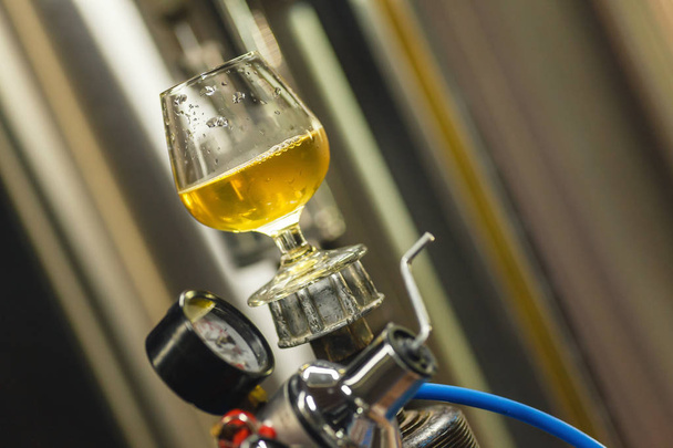 Ποτήρι μπίρα σε μια δεξαμενή αερίου - Φωτογραφία, εικόνα