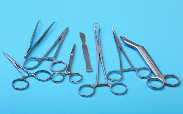 Close Up Surgical instruments and tools on blue mirror background. Selective focus. - Foto, immagini