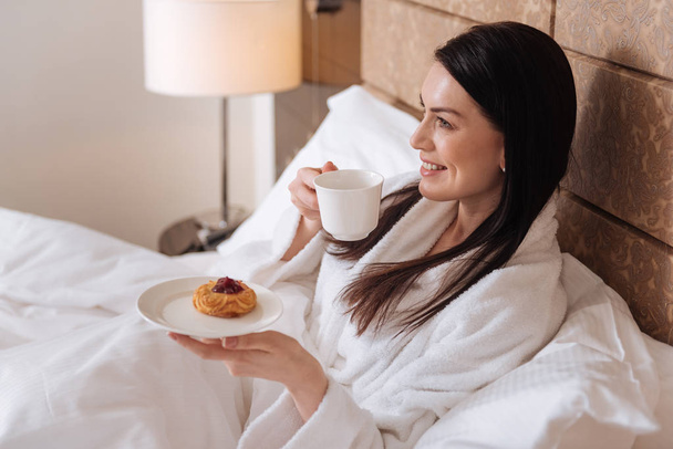 woman lying in bed and having tea - Foto, Imagen