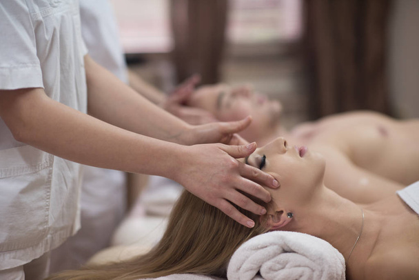 couple enjoying head massage at the spa - Photo, Image