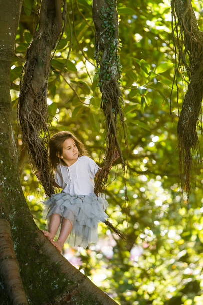 outdoor portrait of young child girl in magic forest  - Фото, изображение
