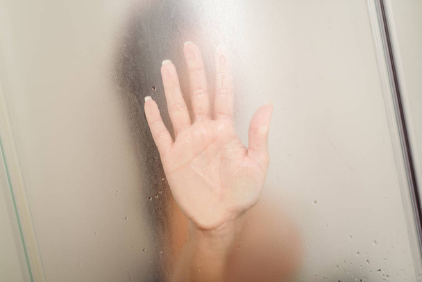 woman in a shower cabin - Фото, изображение