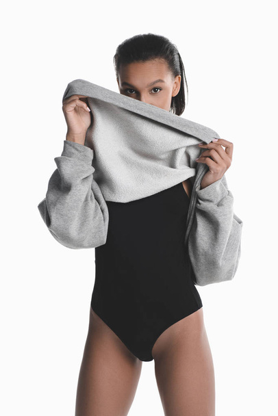 Young woman in bodysuit and sweater  - Фото, зображення