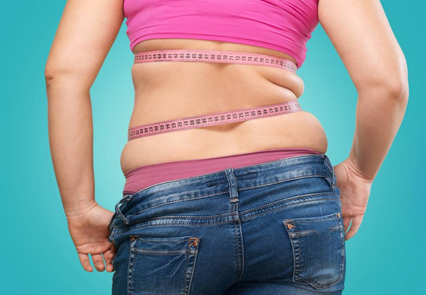 fat woman measuring her stomach - Fotoğraf, Görsel