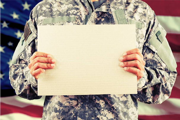 military man holding sign board - Foto, Bild