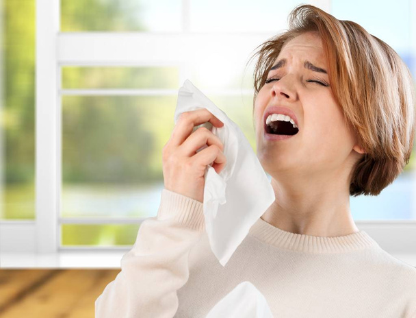 ill woman with napkin sneezing - 写真・画像