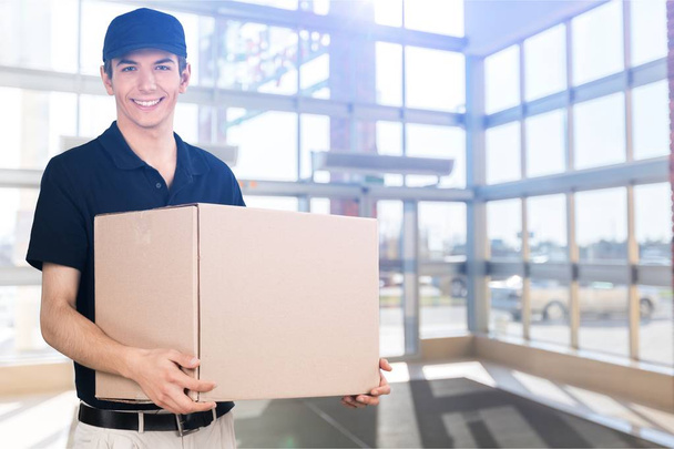 young handsome courier with box - Foto, immagini