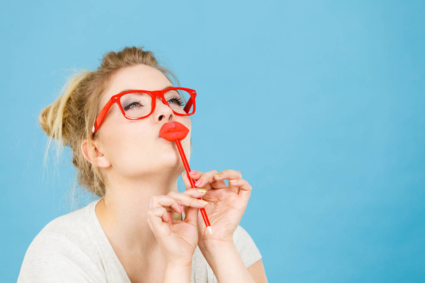 Happy woman holding fake lips on stick - Valokuva, kuva