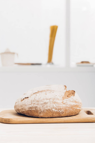 Fresh baked bread on wooden table. soft light - Foto, Imagem