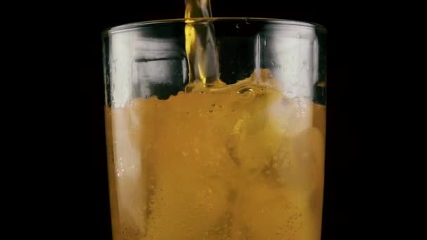 Slow mo. Filled glass with orange drink - Materiaali, video