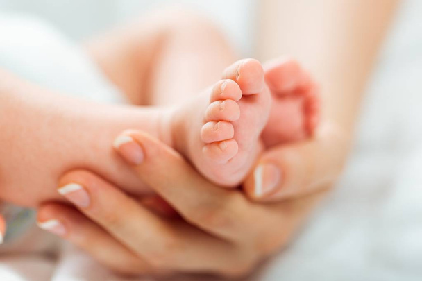Baby feet in the mother hand - Фото, зображення