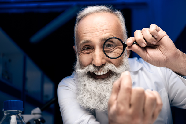 scientist with magnifying glass - Photo, image
