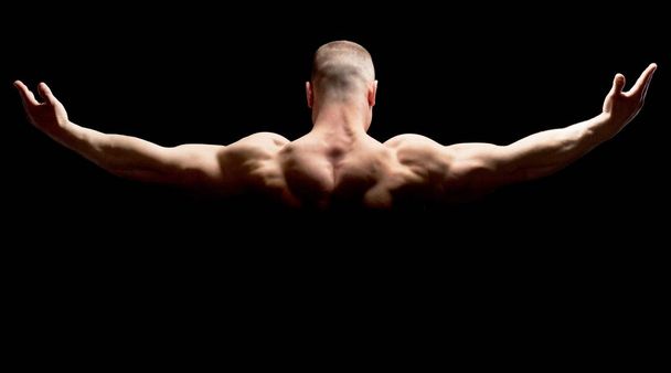 Bodybuilder showing his muscles - Фото, изображение