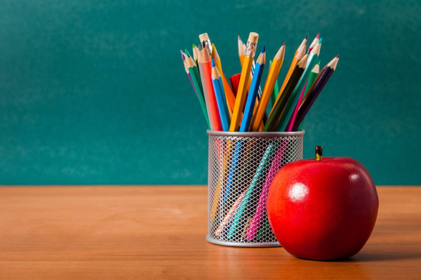 Colorful pencils in jar and apple - Photo, Image
