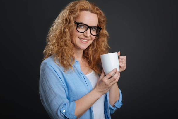 woman holding a cup with warm drink - Zdjęcie, obraz