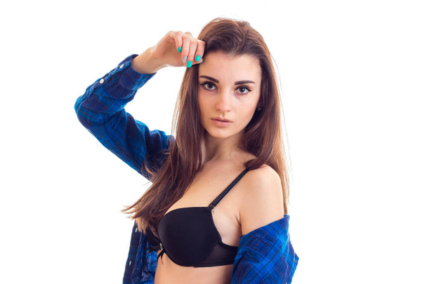 beautiful young brunette girl take off her blue shirt and looking at the camera - Zdjęcie, obraz