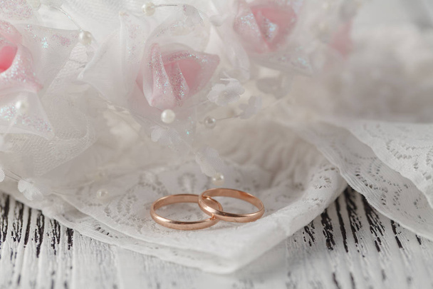 Wedding rings on white satin - 写真・画像