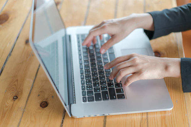 Closeup of business woman hand typing on laptop keyboard . - Foto, imagen