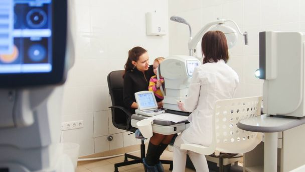 Doctor optometrist examines the sight of a small child - Photo, Image