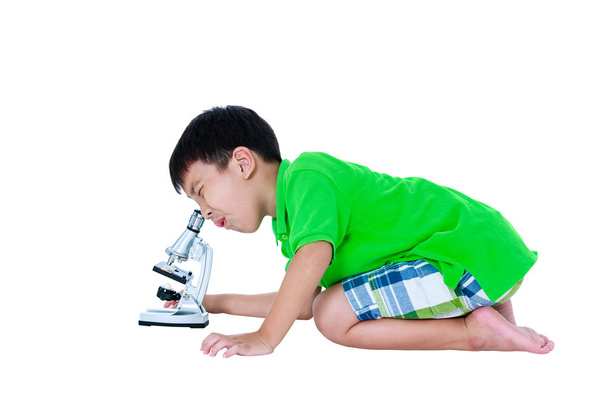 Asian child observed through a microscope biological preparations with copy space. - Photo, Image